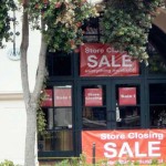 Sale signs on windows under tree Store Closing Plans for you store closing sale