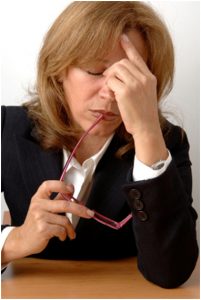 Image of a business woman holding her head as if she heard of Retail Business Failures