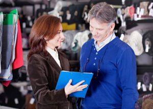 Woman and man looking at a file in a retail store setting store closing consultant